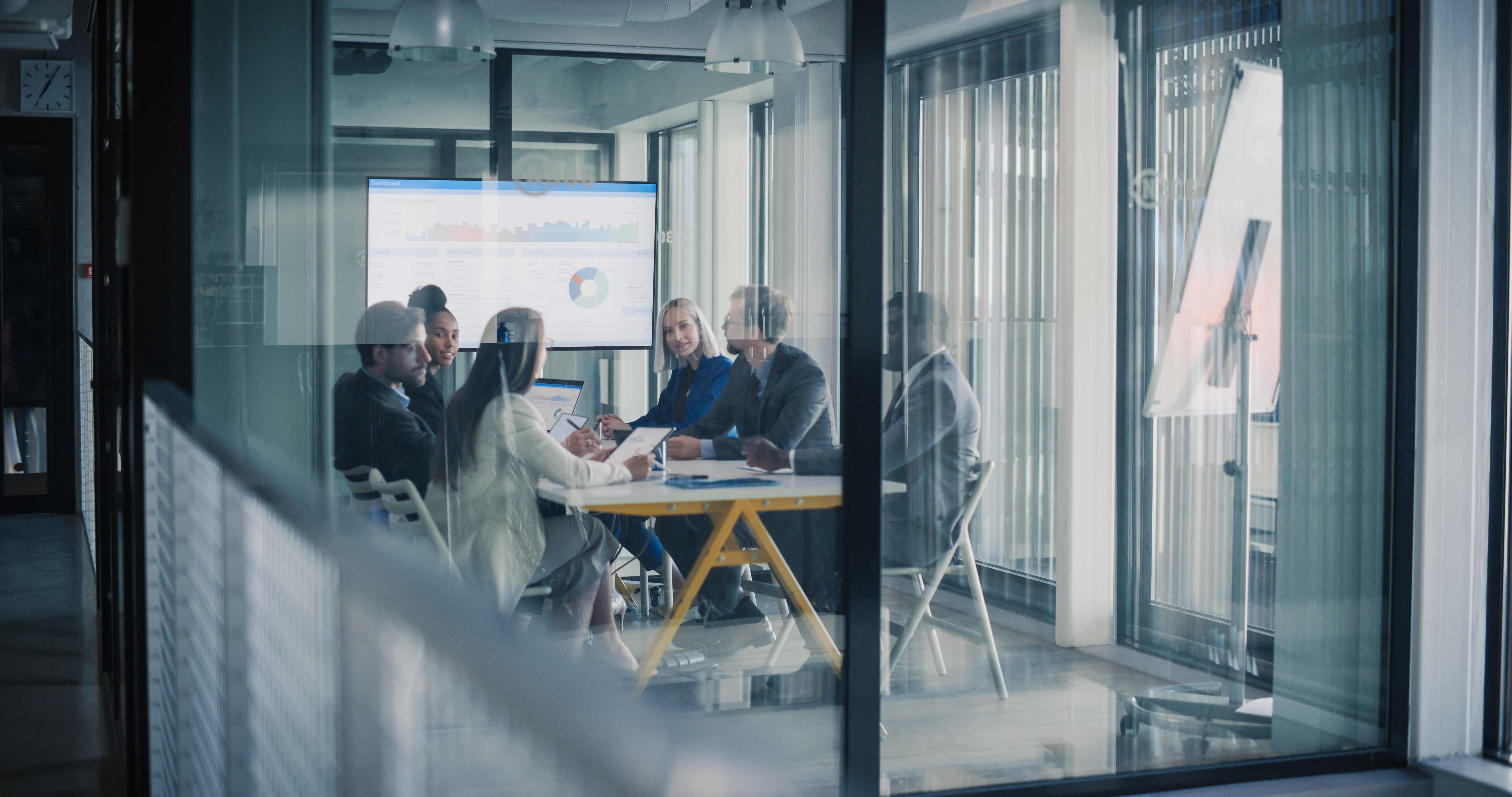 Business,Team,Meets,In,A,Glass,Conference,Room,To,Review